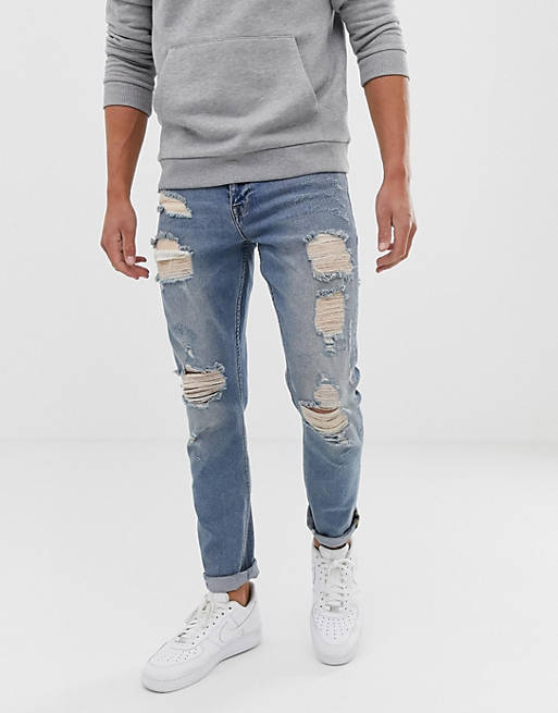 ASOS DESIGN stretch slim jeans in vintage light wash blue with heavy rips