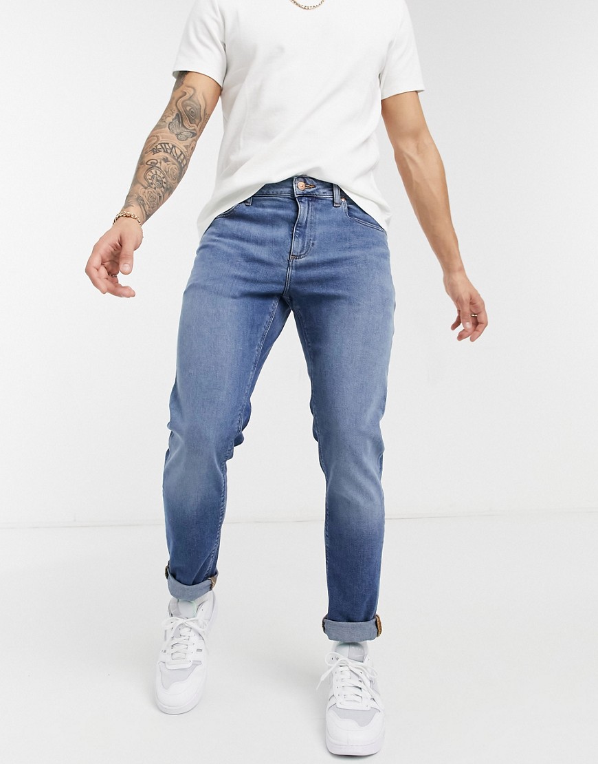 ASOS DESIGN stretch slim jeans with sustainable 'less thirsty' wash in mid blue-Blues