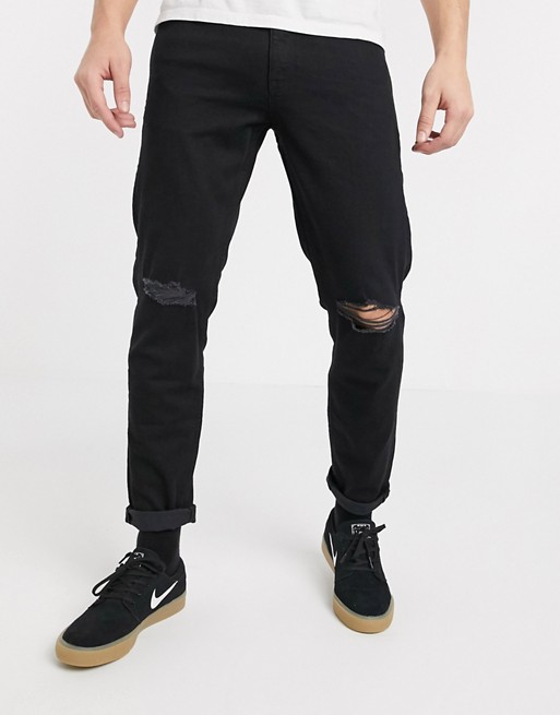ASOS DESIGN stretch tapered jeans in black with knee rips