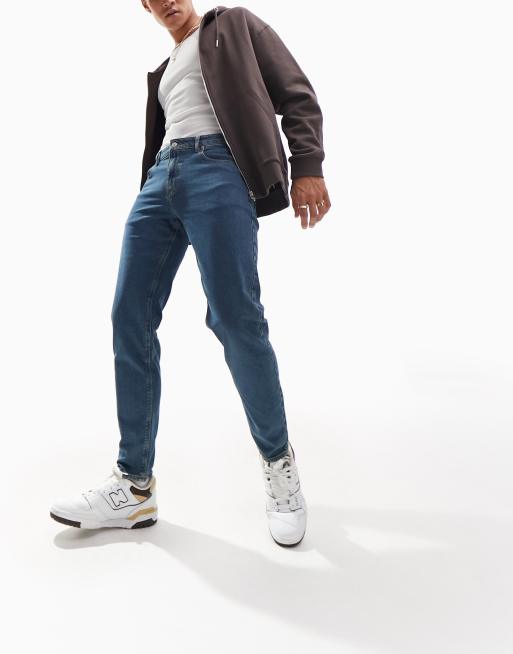 ASOS DESIGN stretch tapered jeans in 90s mid wash