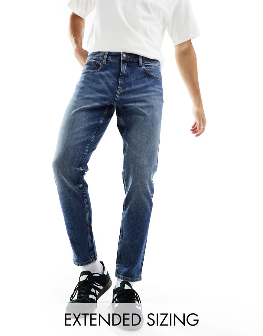ASOS DESIGN stretch tapered jeans in dark wash blue