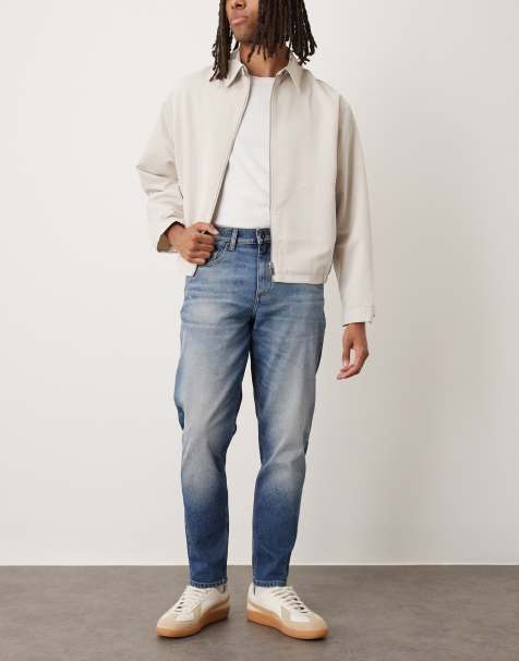 ASOS DESIGN stretch tapered jeans in dark wash blue - view 1