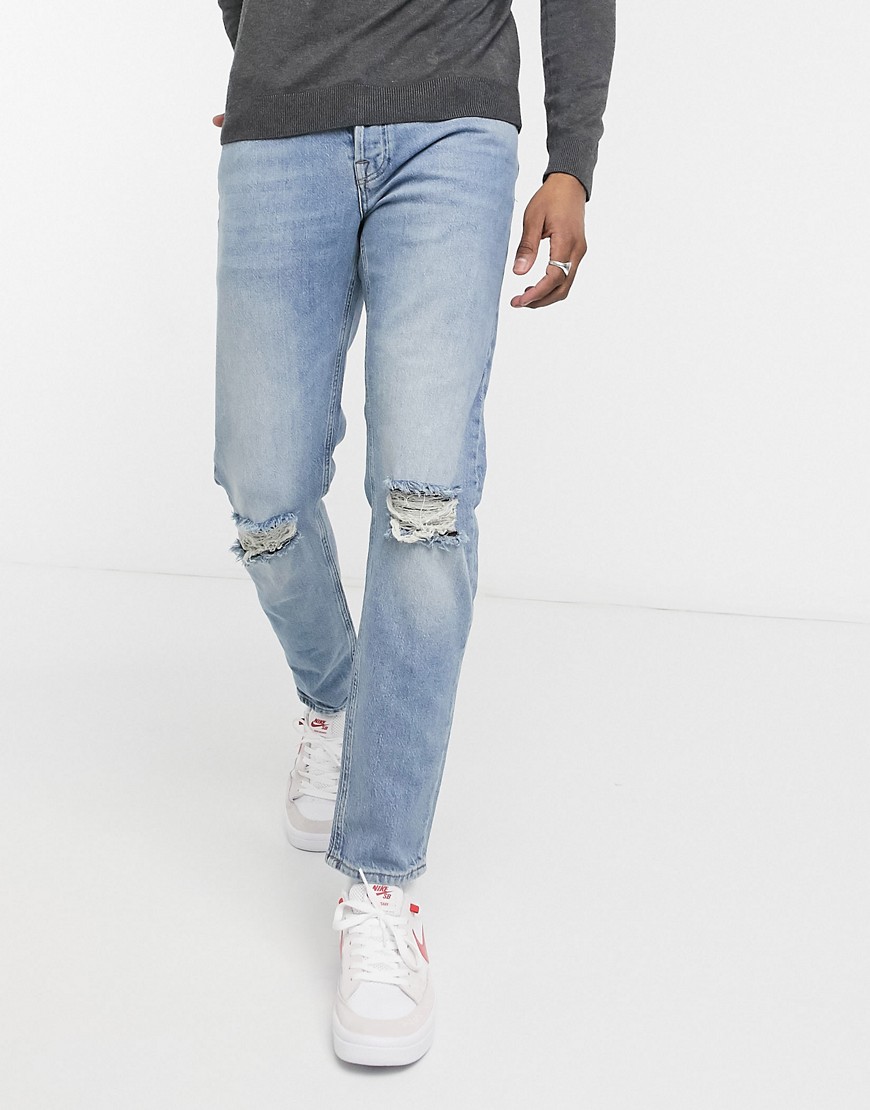 ASOS DESIGN stretch tapered jeans in light wash blue with knee rips