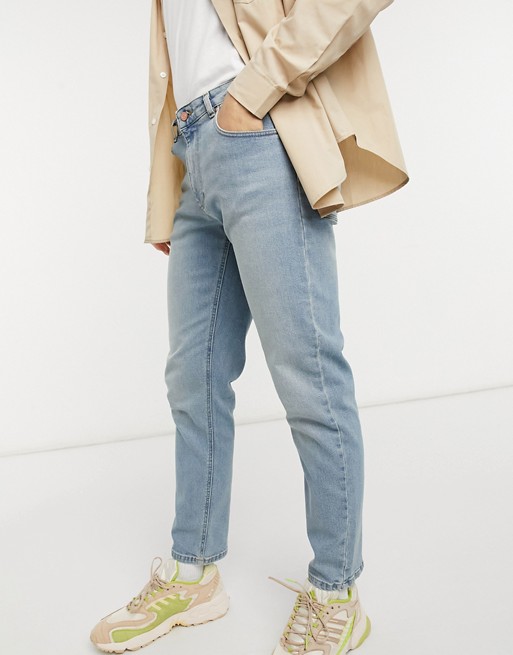 ASOS DESIGN stretch tapered jeans in light wash blue