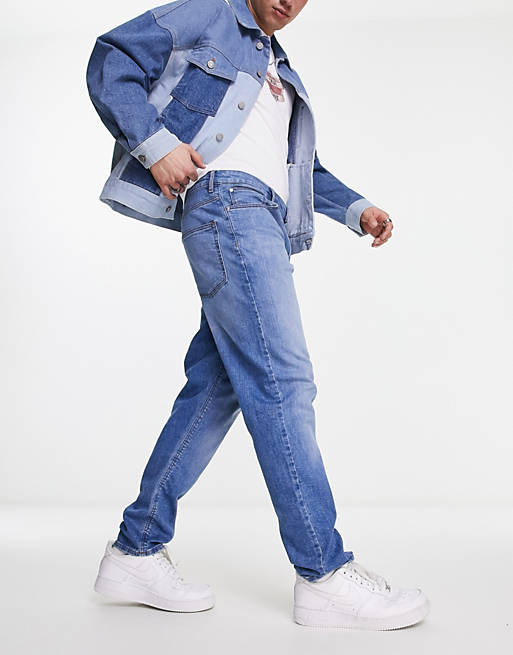 ASOS DESIGN stretch tapered jeans in light wash blue | ASOS