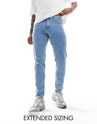 ASOS DESIGN stretch tapered jeans in light wash blue