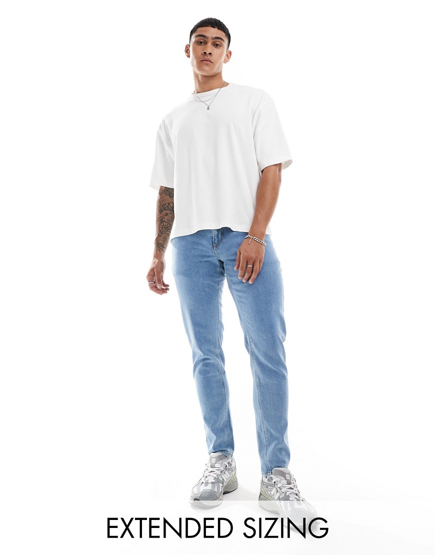 ASOS DESIGN stretch tapered jeans in light wash blue