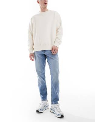 ASOS DESIGN STRETCH TAPERED JEANS IN LIGHT WASH-BLUE