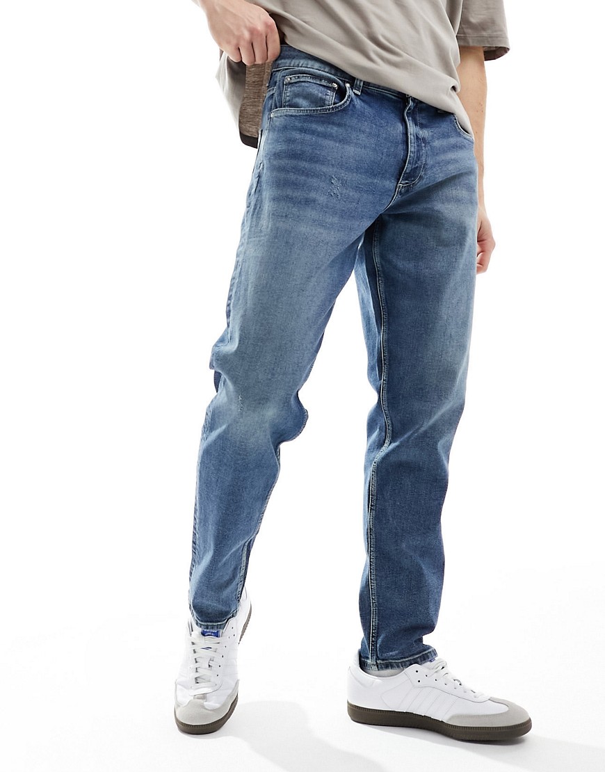 ASOS DESIGN stretch tapered jeans in mid wash blue