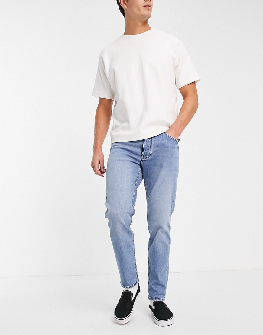 ASOS DESIGN stretch tapered jeans in mid wash-Blues