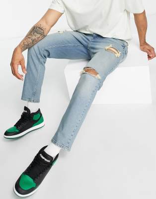 ASOS DESIGN stretch tapered jeans in tinted blue wash with rips
