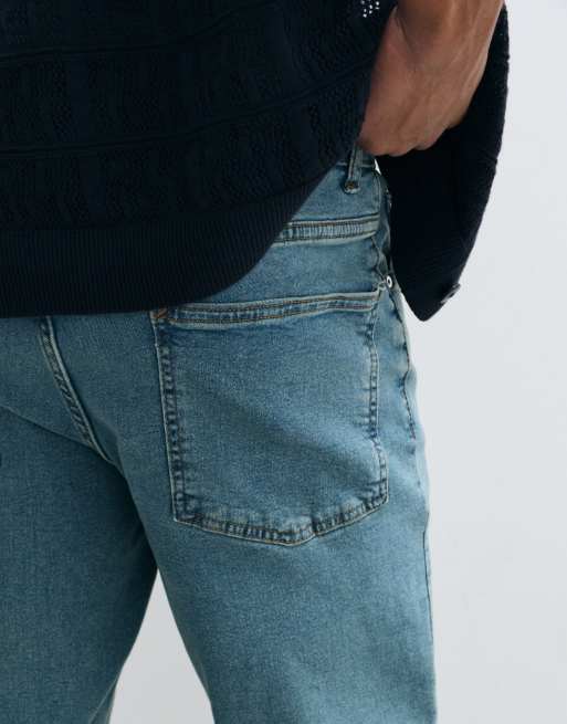 ASOS DESIGN stretch tapered jeans in tinted light wash blue, 3 of 5