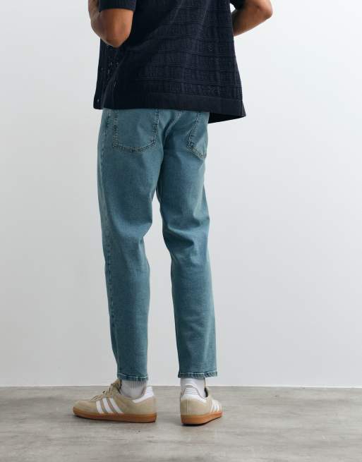 ASOS DESIGN stretch tapered jeans in tinted light wash blue, 4 of 5