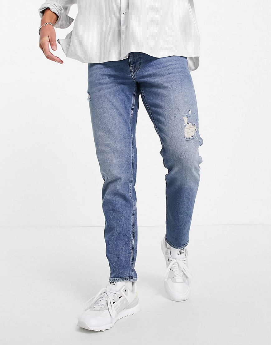 ASOS DESIGN stretch tapered jeans in vintage dark wash with abrasions-Blues