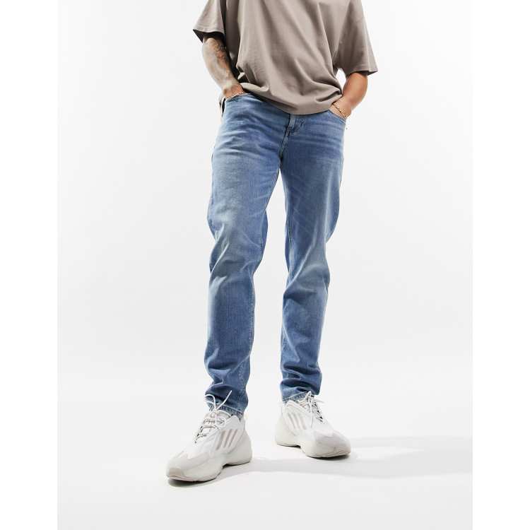 ASOS DESIGN stretch tapered jeans in vintage light wash blue ASOS