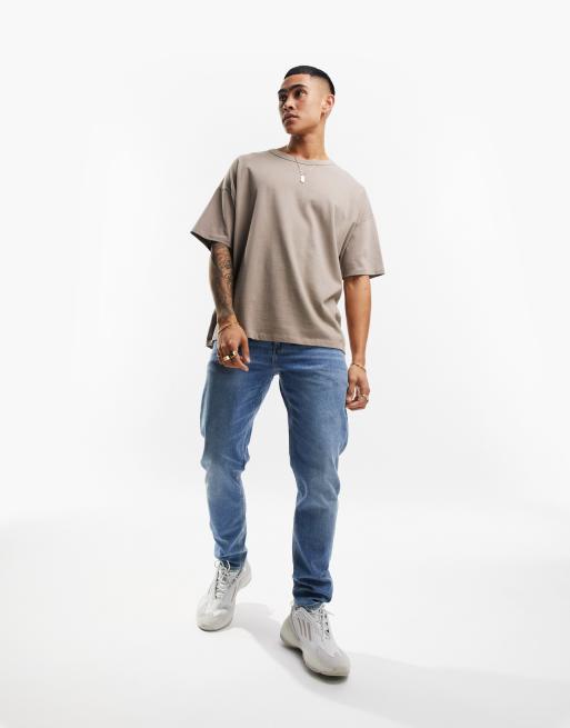 ASOS DESIGN stretch tapered jeans in 90s mid wash