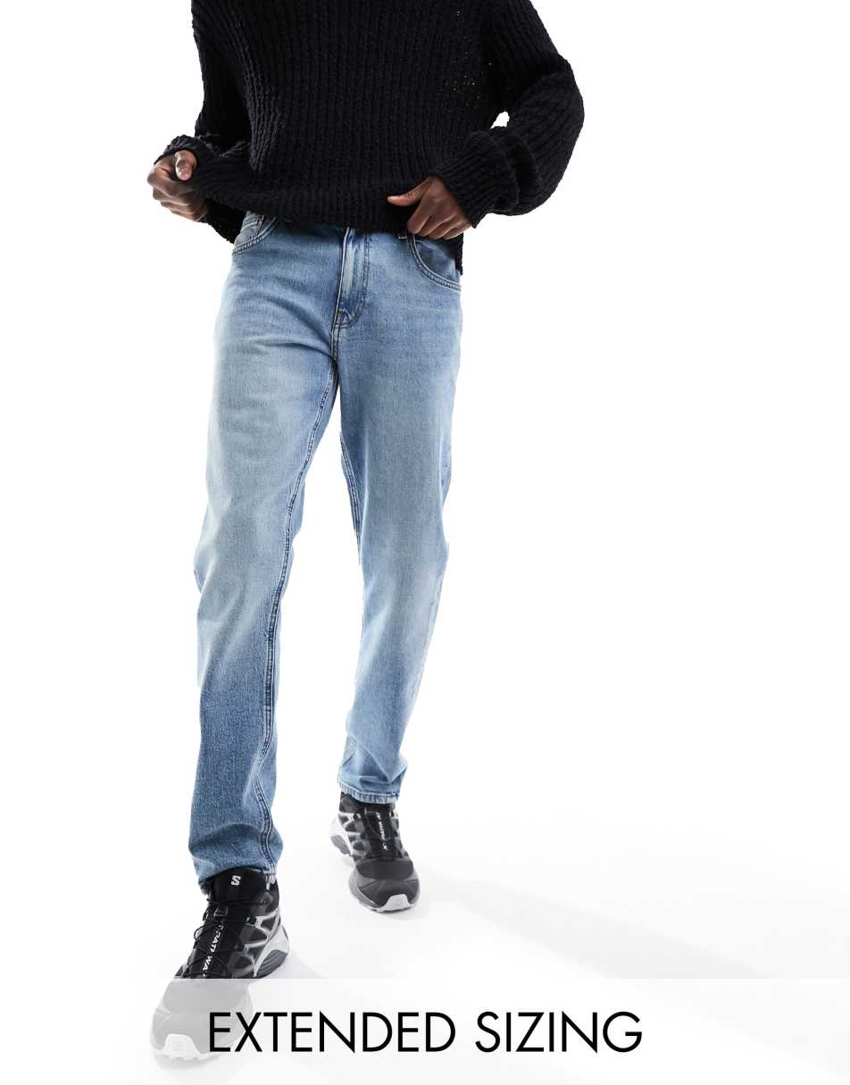 ASOS DESIGN stretch tapered jeans in vintage mid blue wash