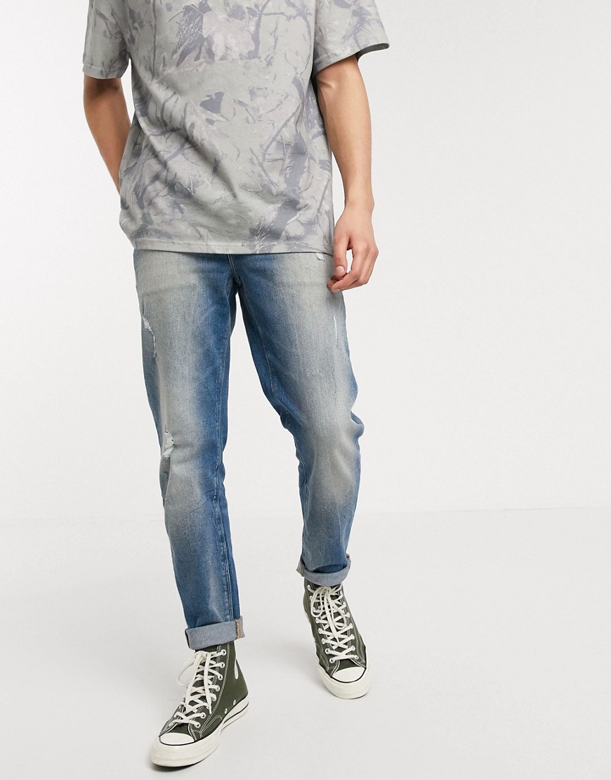 ASOS DESIGN stretch tapered jeans in vintage mid wash blue with abrasions