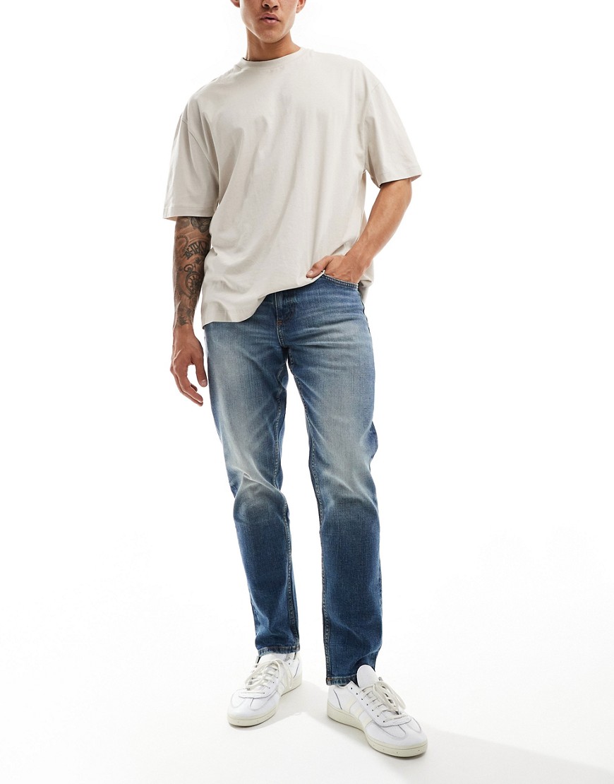 ASOS DESIGN stretch tapered jeans in vintage mid wash blue