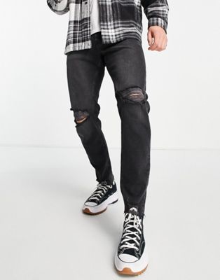 ASOS DESIGN stretch tapered jeans in washed black with rips