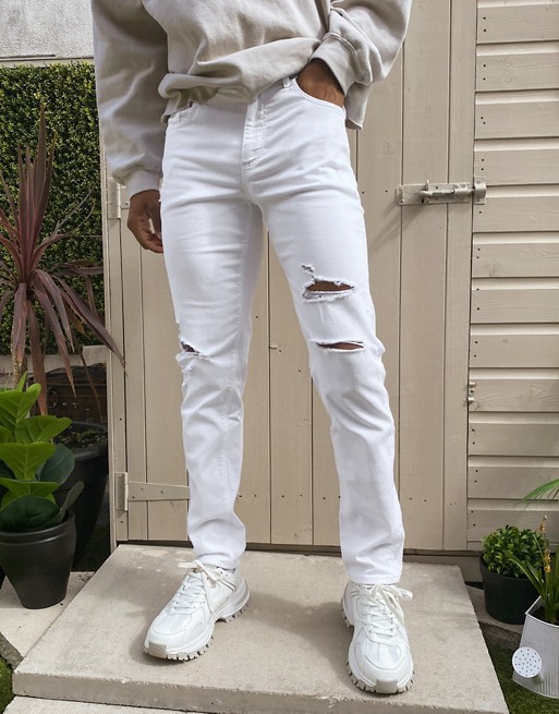 ASOS DESIGN stretch tapered jeans in white with rips