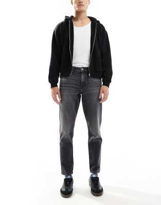 stretch tapered jeans with vintage tint in washed black