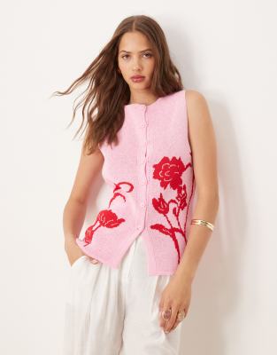 ASOS DESIGN - Strukturierte Strickweste in Rosa mit Placement-Blumenmotiv