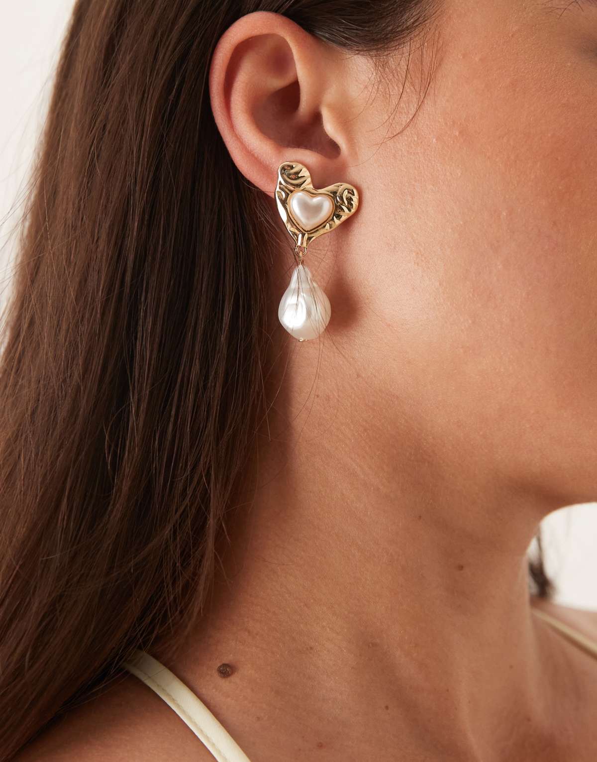 ASOS DESIGN stud earrings in textured heart design with faux pearl drop in gold tone