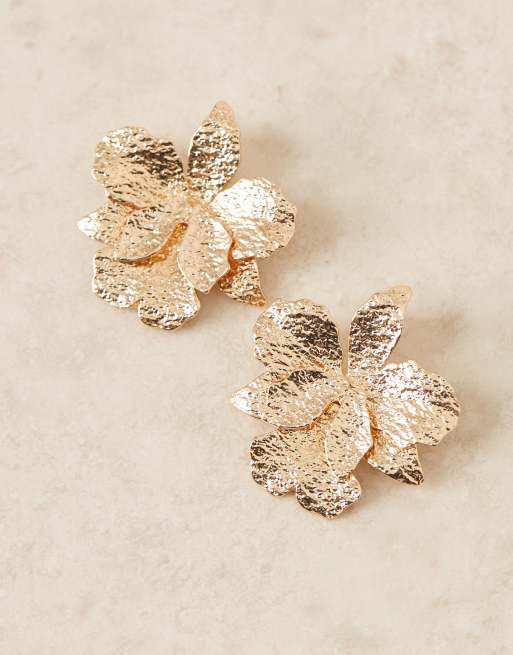 ASOS DESIGN stud earrings with hammered floral detail in gold tone