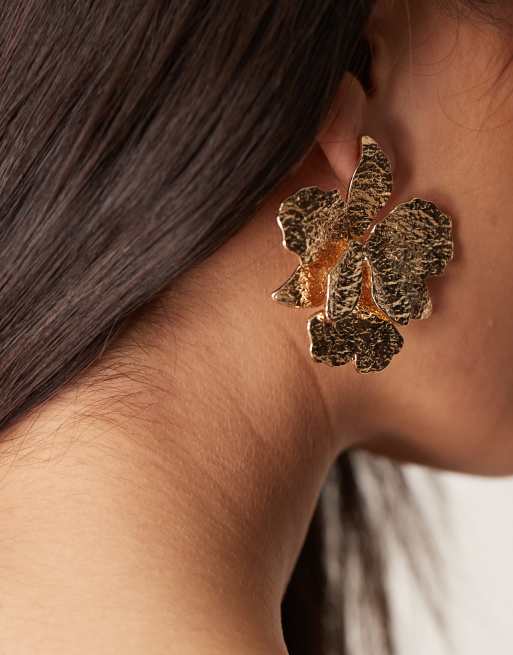 ASOS DESIGN stud earrings with hammered floral detail in gold tone