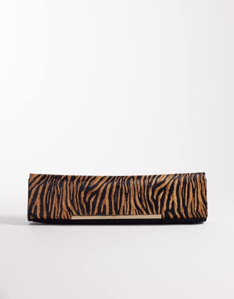 ASOS DESIGN suede & hair on real leather with tiger print elongated clutch bag with bar detail - view 1