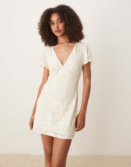 ASOS DESIGN – Sukienka mini z rozkloszowanymi rękawami i dekoltem w kształcie litery V w kolorze neutralnym we wzór devore