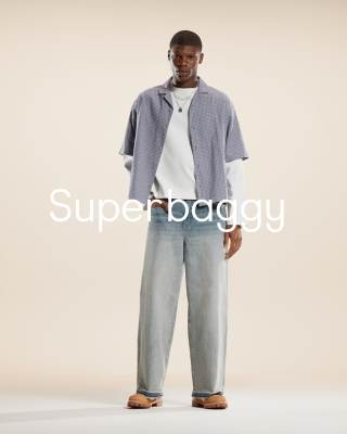 ASOS DESIGN super baggy jeans with purple tint in light wash blue