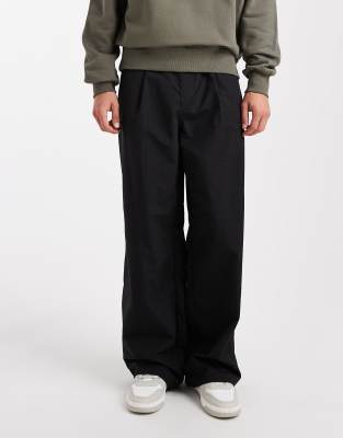 super baggy pants in black nylon with pleats