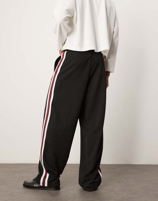 ASOS DESIGN super baggy trackies with pintucks and side panels in black ...
