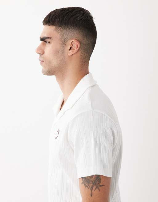 ASOS DESIGN super heavyweight regular fit polo with chest graphic in white rib fabric, 4 of 5