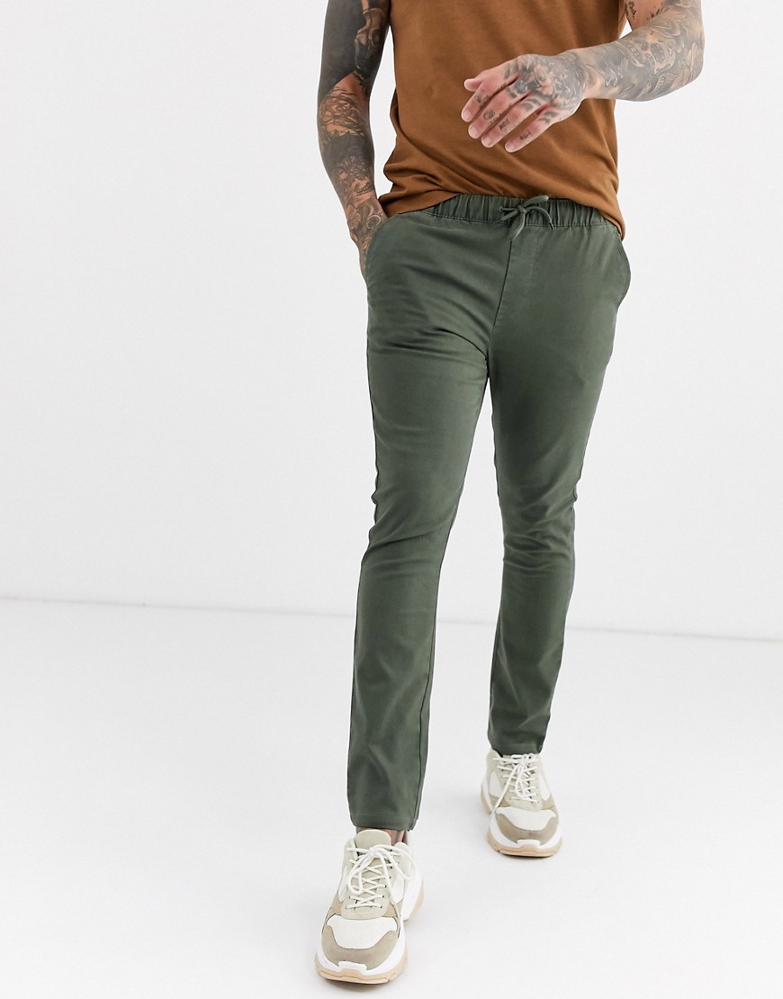ASOS DESIGN super skinny chinos with elastic waist in washed khaki-Green