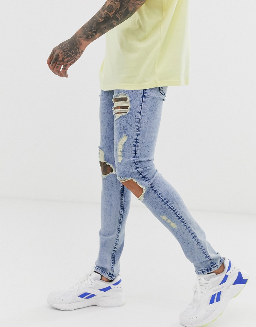 ASOS DESIGN super skinny jeans in acid wash blue with open rips