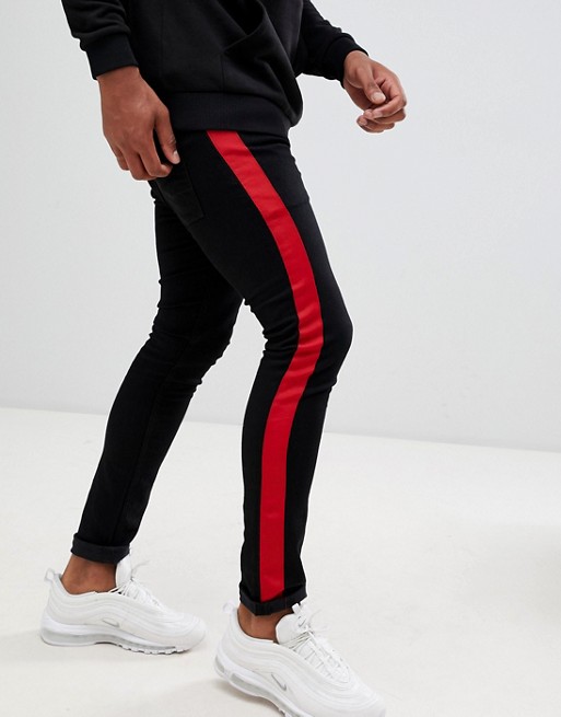 ASOS DESIGN super skinny jeans in black with red side stripe | ASOS