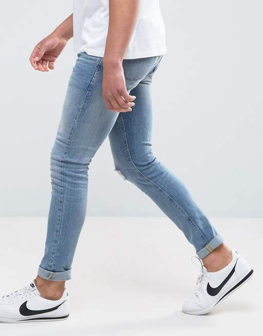 ASOS DESIGN skinny jeans with moto detail in blue