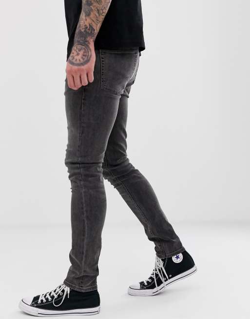 ASOS DESIGN super skinny jeans in washed black with paint splatter