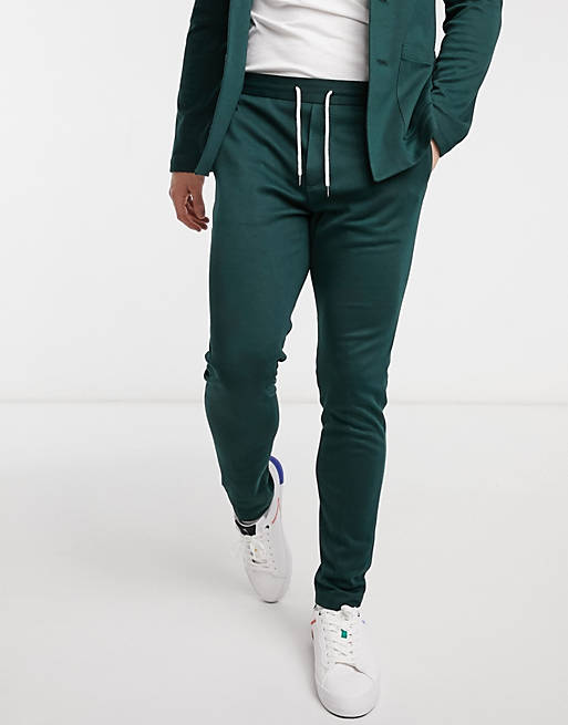 Men super skinny soft tailored suit trousers in jersey in bottle green 