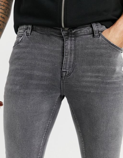 ASOS DESIGN super skinny jeans in washed black with paint splatter