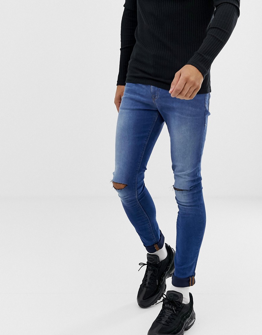 ASOS DESIGN super spray on jeans with knee rips in mid blue