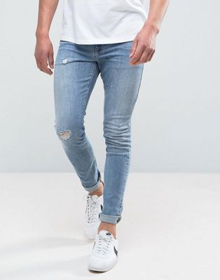 ASOS DESIGN – Superenge Skinny-Jeans in verwaschenem Mittelblau mit Abnutzungen