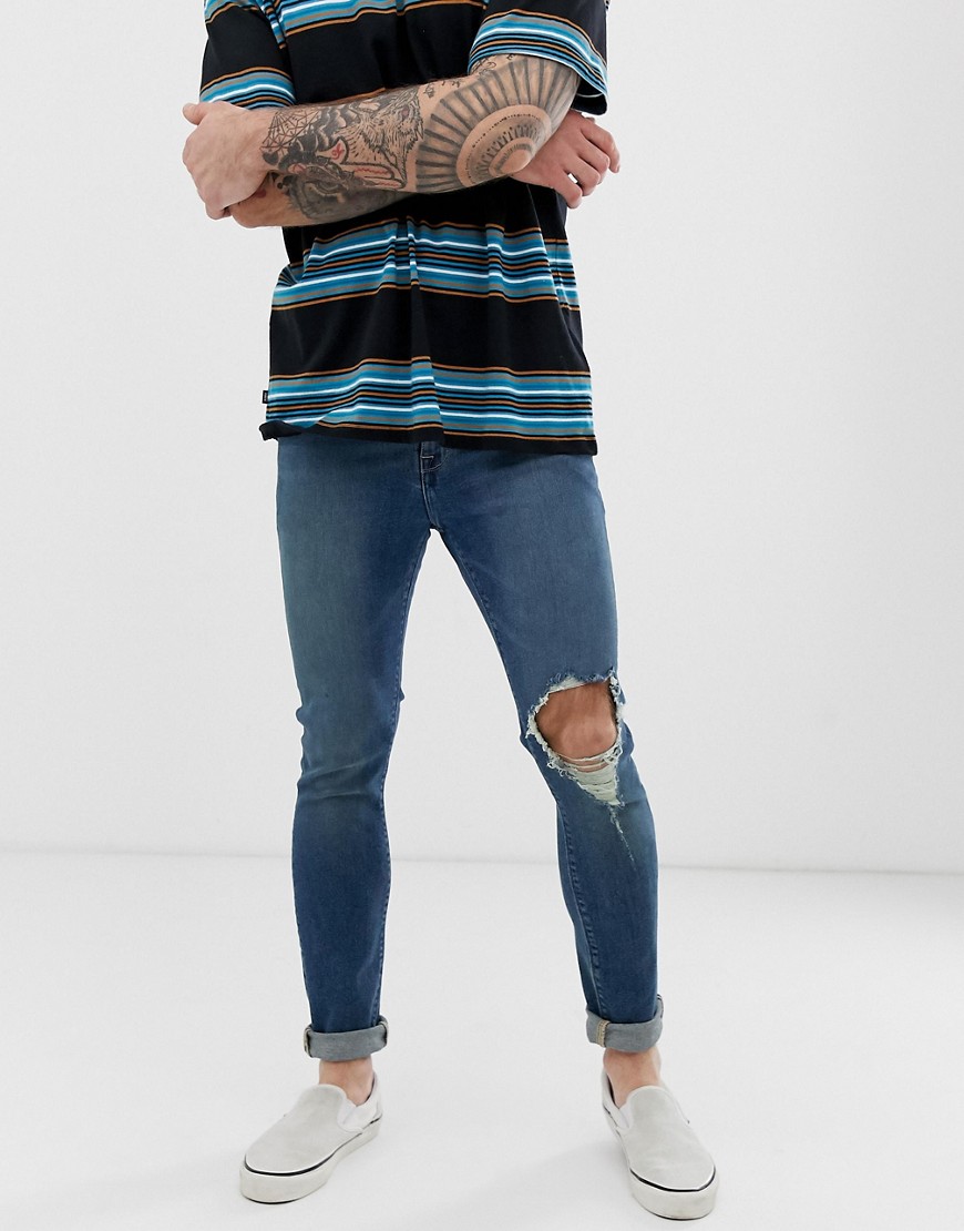 ASOS DESIGN - Superskinny jeans met mid wash en scheuren op de knie in blauw