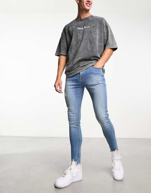 ASOS DESIGN - Superstrakke jeans met powerstretch en slijtageplekken in blauw