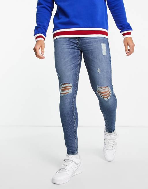 ASOS DESIGN - Superstrakke jeans met powerstretch in donkerblauwe wassing met grote scheuren