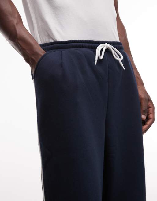 ASOS DESIGN – Superweite Jogginghose in Marineblau mit seitlicher Paspelierung, Kombiteil, 4 von 7