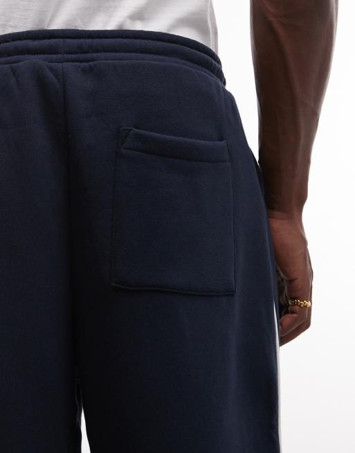 ASOS DESIGN – Superweite Jogginghose in Marineblau mit seitlicher Paspelierung, Kombiteil, 5 von 7